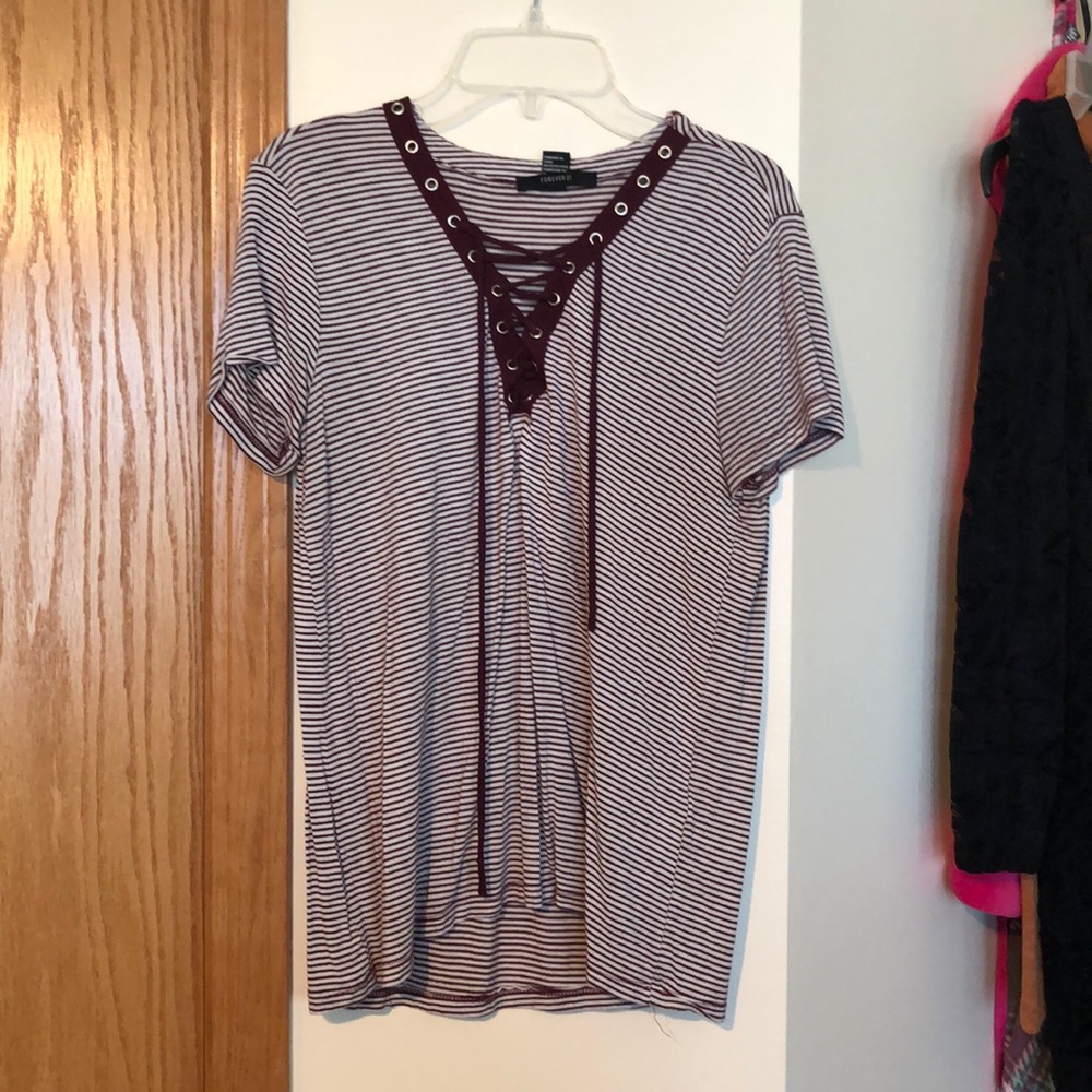 A maroon and white striped t shirt with strings